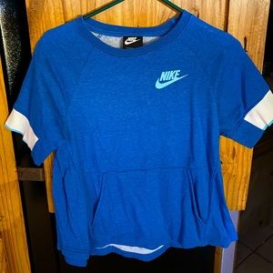 The brand is Nike. The material is like a sweatshirt. Shortsleeved.  Adult XS